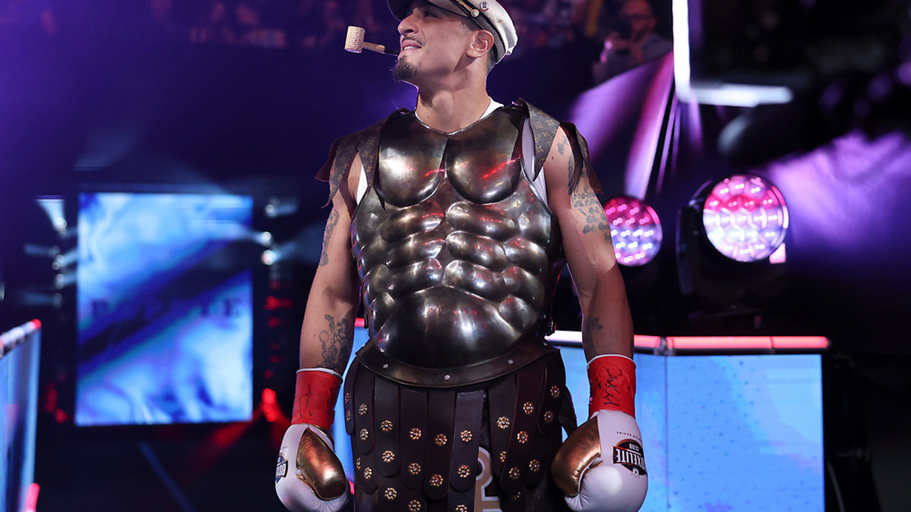 Richard Popeye Rivera ringwalk in gladiator armor wearing BOXELITE S-PRO white and gold professional boxing gloves at Barclays Center
