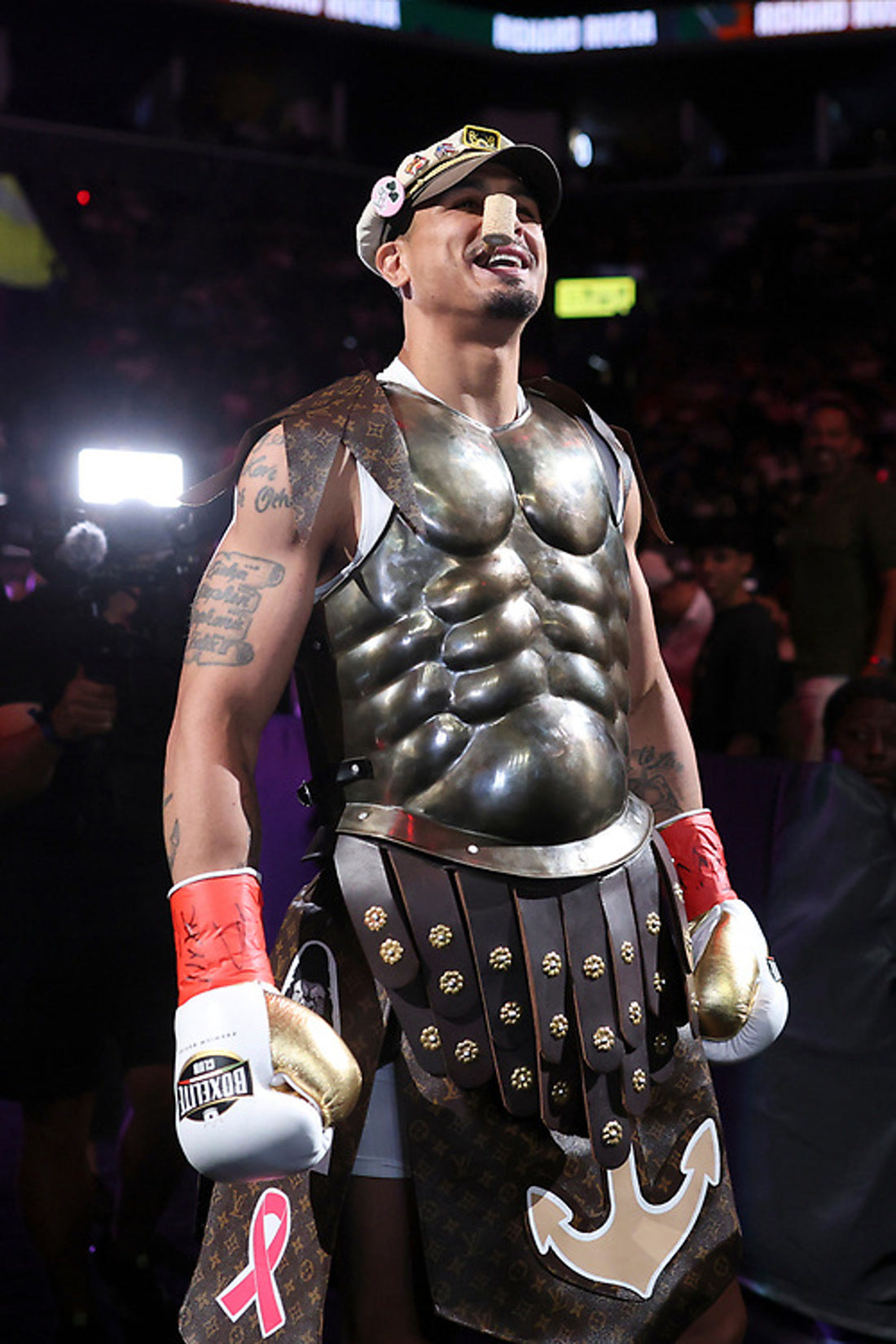 Richard Popeye Rivera smiling in his gladiator armor before the Whittaker fight wearing BOXELITE professional boxing gloves
